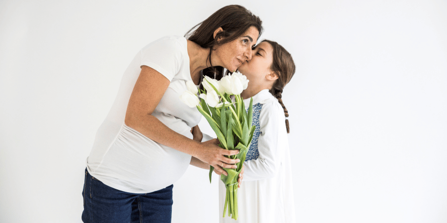 Pregnant women kissed by a little girl